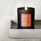 Makagi Golden Hour Duftkerze 70g in einer schwarzen Dose, mit brennendem Docht und weichem, atmosphärischem Hintergrund. Der Duft verbindet Tabak, Honig und Tonka für ein einzigartiges, Duft Erlebnis.